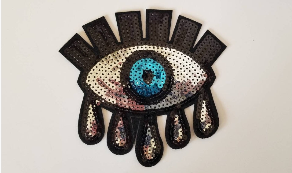 Protective blue sequined iron-on eye patch