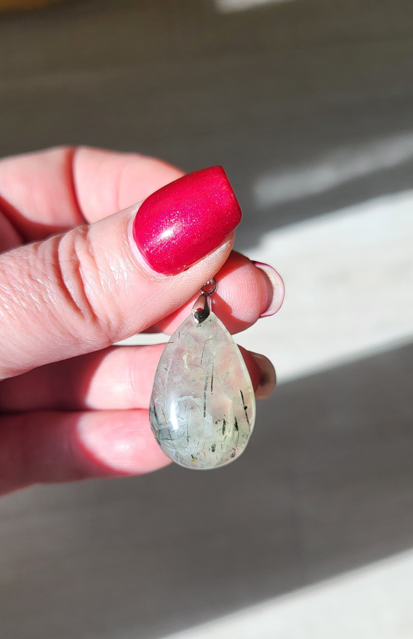 Necklace with prehnite pendant and tourmaline inclusions
