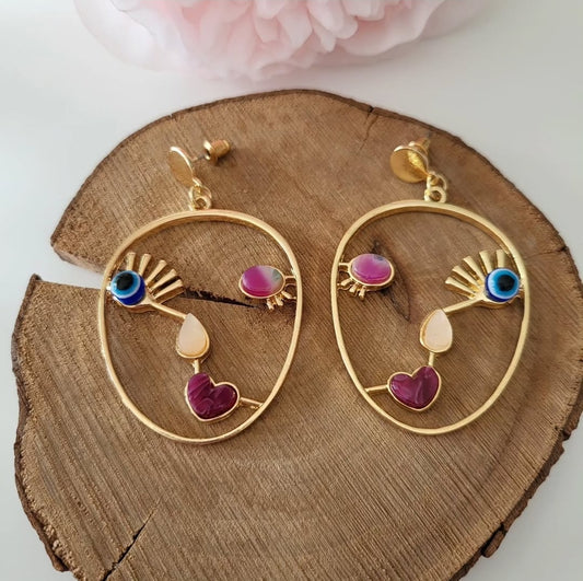 Picasso earrings with selenite and garnet stones.