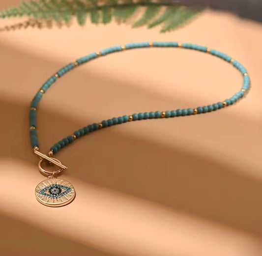Necklace with protective eye medallion